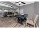 Open dining area featuring hardwood floors and a ceiling fan next to the large living room at 119 N Hillcrest Ave, Clearwater, FL 33755