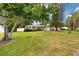 Charming single-story home with a well-manicured lawn, trees, and a one-car garage at 119 N Hillcrest Ave, Clearwater, FL 33755