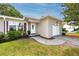 Charming single-story home with a well-manicured lawn, trees, and a one-car garage at 119 N Hillcrest Ave, Clearwater, FL 33755