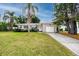 Charming single-story home with a well-manicured lawn, palm trees, and a one-car garage at 119 N Hillcrest Ave, Clearwater, FL 33755