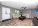 A cozy living room with a ceiling fan, leather sofas, and wood-look vinyl floors at 119 N Hillcrest Ave, Clearwater, FL 33755