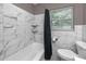 Bright bathroom featuring a shower and tub with white marble tiling at 119 N Hillcrest Ave, Clearwater, FL 33755
