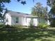 View of the home's backyard featuring verdant green grass and a serene atmosphere at 11951 Wichers Ln, San Antonio, FL 33576
