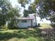 Scenic backyard offering a peaceful escape with mature trees and a beautiful lawn at 11951 Wichers Ln, San Antonio, FL 33576
