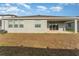 Exterior view of backyard, with a covered patio accessible by sliding glass doors at 12436 Shining Willow St, Riverview, FL 33579