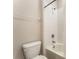 Bright bathroom with white tiled shower and a toilet with a matching white tank and seat at 12436 Shining Willow St, Riverview, FL 33579