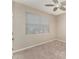 Bright bedroom features neutral paint, carpet, a ceiling fan and a large window with blinds at 12436 Shining Willow St, Riverview, FL 33579