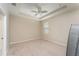 Bright bedroom with neutral paint, carpet, ceiling fan, and tray ceiling at 12436 Shining Willow St, Riverview, FL 33579