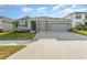 Charming single-Gathering home boasts a well-manicured lawn and a two-car garage at 12436 Shining Willow St, Riverview, FL 33579