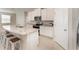 Bright kitchen features granite countertops, stainless steel appliances, tile flooring and a breakfast bar with stool seating at 12436 Shining Willow St, Riverview, FL 33579