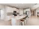 Modern kitchen boasts granite counters, white cabinets, stainless appliances and a large breakfast bar with seating at 12436 Shining Willow St, Riverview, FL 33579