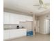 Bright kitchenette with modern cabinets, granite countertop, ceiling fan, and neutral paint at 12436 Shining Willow St, Riverview, FL 33579