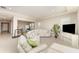 Spacious living room with tile floors, neutral paint and a large sectional sofa at 12436 Shining Willow St, Riverview, FL 33579