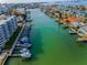 Aerial view of waterfront building featuring boat docks and beautiful waterfront view at 125 Island Way # 502, Clearwater Beach, FL 33767