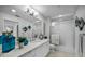 This bathroom features a double vanity, a glass shower, and tile floors at 125 Island Way # 502, Clearwater Beach, FL 33767