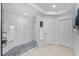 This bathroom features a tiled shower with a glass door, bench and marble floors at 125 Island Way # 502, Clearwater Beach, FL 33767