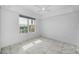 This bedroom features tile floors, a ceiling fan and a window with city views at 125 Island Way # 502, Clearwater Beach, FL 33767
