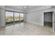 This bedroom features marble tile floors, a ceiling fan and a sliding glass door to a balcony with water views at 125 Island Way # 502, Clearwater Beach, FL 33767