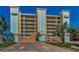 Condo building showing architectural details and entrances with lush tropical landscaping at 125 Island Way # 502, Clearwater Beach, FL 33767