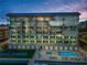 An exterior shot of a condo building that features balconies with pool and waterfront views at 125 Island Way # 502, Clearwater Beach, FL 33767