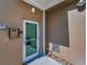 Tan building exterior featuring secure lobby door with keypad entry and small garden area at 125 Island Way # 502, Clearwater Beach, FL 33767