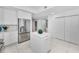 Modern kitchen showcasing stainless steel appliances, an island, white cabinets, and striking tiled flooring at 125 Island Way # 502, Clearwater Beach, FL 33767
