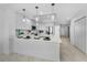 Modern kitchen with stainless steel appliances, center island, and stylish pendant lighting at 125 Island Way # 502, Clearwater Beach, FL 33767
