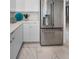 Close up on a refrigerator with stainless steel finish with tiled floors and white cabinets at 125 Island Way # 502, Clearwater Beach, FL 33767