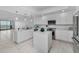 Spacious kitchen with an island, stainless steel appliances, and sleek white cabinetry at 125 Island Way # 502, Clearwater Beach, FL 33767