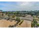 High angle view of neighborhood shopping center with surrounding buildings and lush palm trees in the foreground at 125 Island Way # 502, Clearwater Beach, FL 33767