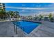Relaxing community pool with lounge chairs, blue skies, and lush tropical landscaping at 125 Island Way # 502, Clearwater Beach, FL 33767