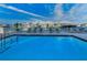 Community pool view with waterfront access and outdoor seating at 125 Island Way # 502, Clearwater Beach, FL 33767