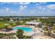Aerial of pool, clubhouse, and recreation areas with neighborhood in the distance at 12710 Wheatgrass Ct, Parrish, FL 34219