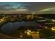 Night aerial view highlighting the community's illuminated waterfront homes and overall landscape at 12710 Wheatgrass Ct, Parrish, FL 34219