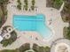 Aerial view of resort pool with slide, lounge seating and ample deck at 12710 Wheatgrass Ct, Parrish, FL 34219