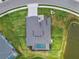 Aerial view of a home with a pool, well-maintained lawn, and a nearby pond creating a private backyard oasis at 12710 Wheatgrass Ct, Parrish, FL 34219