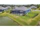 Aerial shot of fenced backyard with pool and spa, overlooking the lake with community views at 12710 Wheatgrass Ct, Parrish, FL 34219