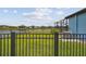 Fenced backyard with lush green grass and water views provides a serene outdoor space at 12710 Wheatgrass Ct, Parrish, FL 34219