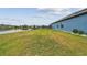 Well-maintained backyard leading to lake and community views; complemented with lush green grass at 12710 Wheatgrass Ct, Parrish, FL 34219