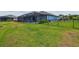 Beautiful backyard with black aluminum fence, lush lawn, and view of the lake at 12710 Wheatgrass Ct, Parrish, FL 34219