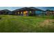 Expansive fenced backyard featuring a screened patio with string lights, perfect for outdoor entertaining at 12710 Wheatgrass Ct, Parrish, FL 34219