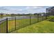 Backyard with black aluminum fence and scenic lake views, perfect for outdoor enjoyment at 12710 Wheatgrass Ct, Parrish, FL 34219