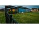 Well-maintained backyard features lush lawn, black fencing, and the home's exterior at 12710 Wheatgrass Ct, Parrish, FL 34219