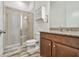 Bathroom features granite countertops, wood-look tile flooring and tiled shower with glass door at 12710 Wheatgrass Ct, Parrish, FL 34219