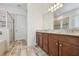 Elegant bathroom showcasing dual vanities, granite countertops, and a glass-enclosed shower at 12710 Wheatgrass Ct, Parrish, FL 34219