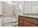 Well-lit bathroom features granite countertops, wood-look tile flooring and tiled shower and tub at 12710 Wheatgrass Ct, Parrish, FL 34219