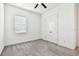 A simple carpeted bedroom features a modern ceiling fan and double door closet at 12710 Wheatgrass Ct, Parrish, FL 34219