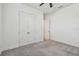 A simple carpeted bedroom features a modern ceiling fan and double door closet at 12710 Wheatgrass Ct, Parrish, FL 34219