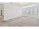 Spacious bedroom with large windows, plush carpet, and designer lighting at 12710 Wheatgrass Ct, Parrish, FL 34219