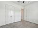 A simple carpeted bedroom features a modern ceiling fan and double door closet at 12710 Wheatgrass Ct, Parrish, FL 34219